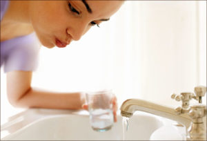 getty_rf_photo_of_woman_rinsing_mouth_with_water